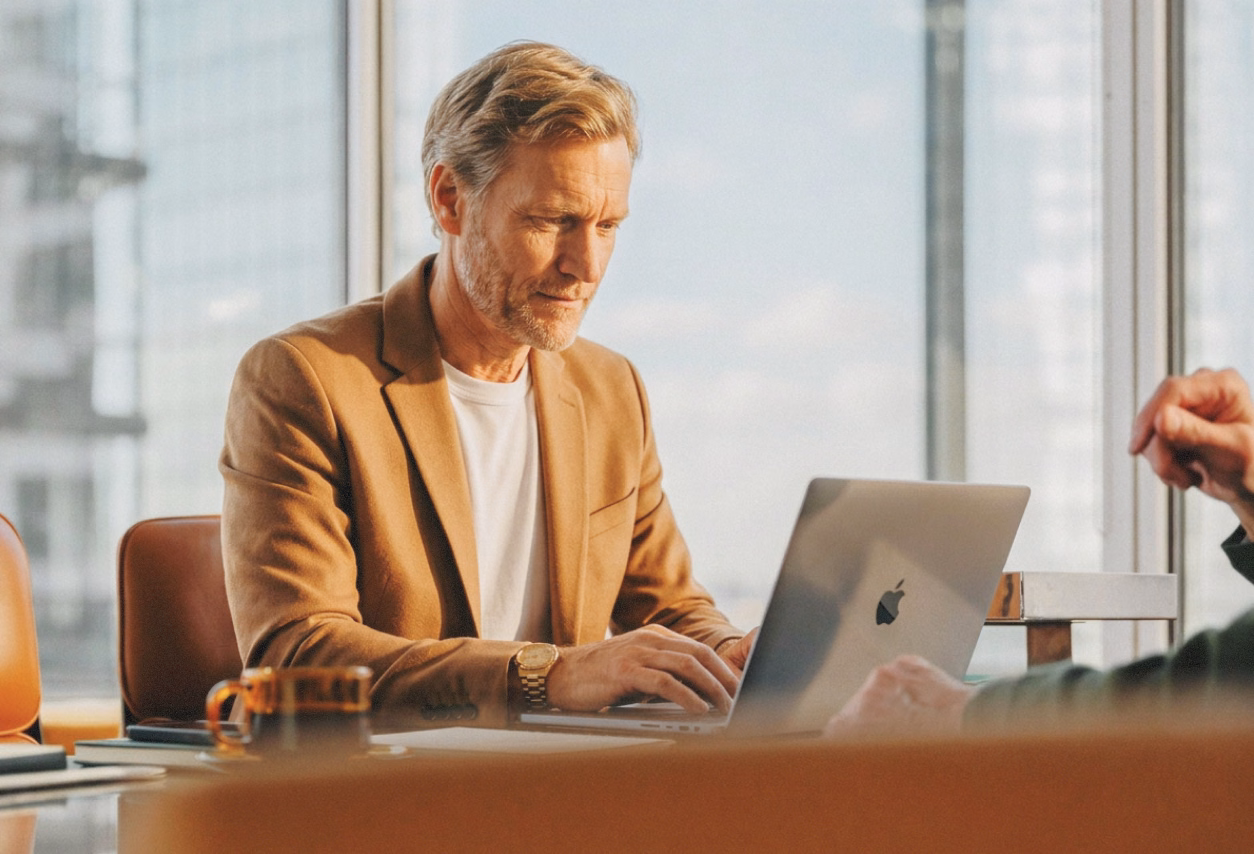A consultant reviewing meeting notes on a laptop